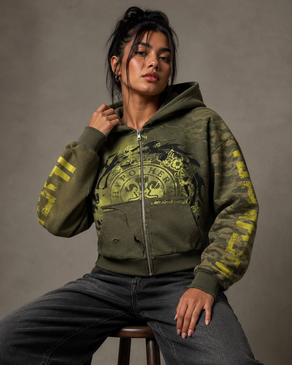 Olive zip hoodie with graphic details in a streetwear lookbook