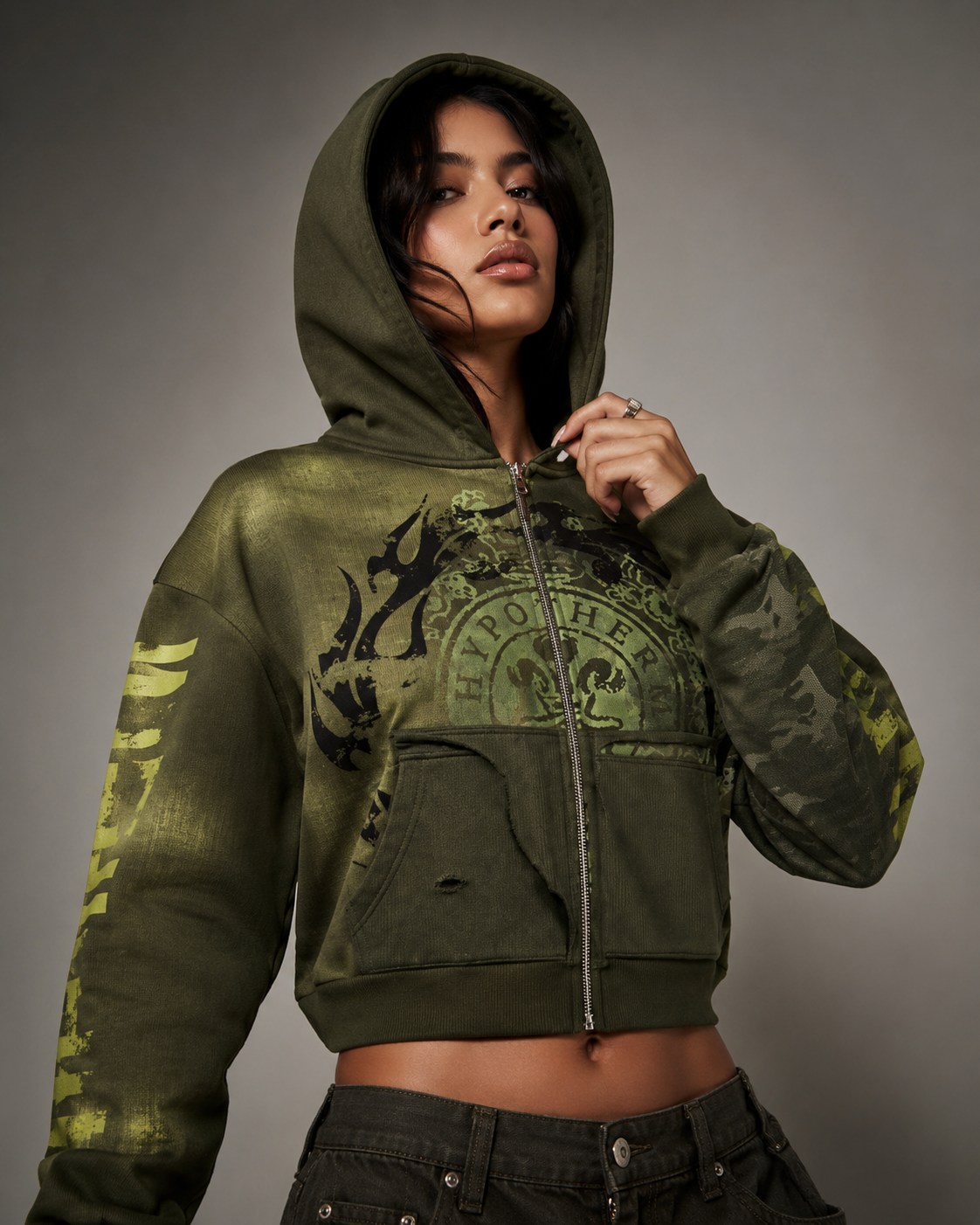 Model wearing an olive Hypotherm Design zip hoodie in an urban streetwear look